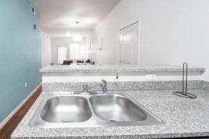 a kitchen with a sink and a counter top at Private 2Bdrm Apartment Convenient to All in Greeley +18 photos