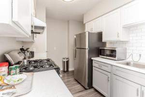 a kitchen with white cabinets and a stainless steel refrigerator at Bargain Memphis apartment w HDTV & WiFi in Memphis