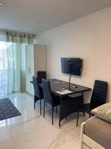 a living room with a dining room table and chairs at City Apartment in Bad Säckingen