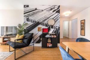 a living room with a wall mural of a piano at Center of DT walking distance to many venues in Macon