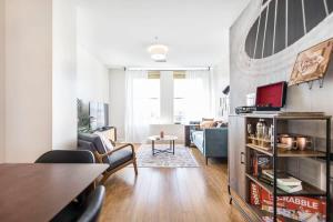 a living room with a couch and a table at The Lofts at Cherry DT w Amenities in Macon