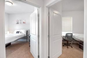 格里利的住宿－3BR Apartment Near University of Northern Colorado，一间卧室配有一张床和一张桌子及椅子
