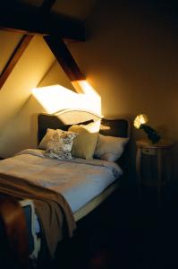 a bedroom with a bed with two lamps on it at Poganty - Mały Domek in Giżycko