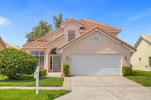 a house with a white garage at Luxury 4BR Home at Ventura Golf and Country Club in Orlando