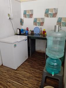 a kitchen with a bottle of water on a table at Bapuji Paying Guest Santacruz West in Mumbai