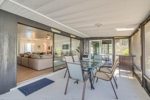 a living room with a glass table and chairs at Charming Riverfront Home with Kayaks! in Crystal River
