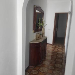 a hallway with a vanity and a mirror in a room at Casa Furtado in Burgau