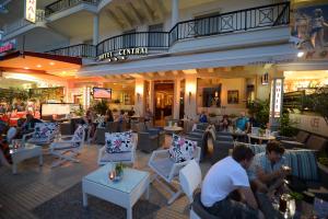 a group of people sitting in a restaurant at Central Hotel in Paralia Katerinis