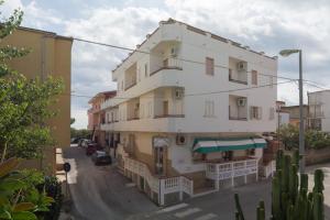 a large white building on the side of a street at Albergo Bed and breakfast FLORIDA in Capo Rizzuto