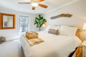 a bedroom with a bed with a ceiling fan at Lakefront Lake Oconee Home Boat Dock and Hot Tub in Eatonton 