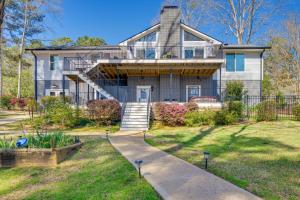 a house with a staircase leading up to it at Lakefront Lake Oconee Home Boat Dock and Hot Tub in Eatonton 