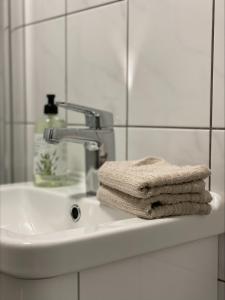 a white bathroom sink with a towel on it at Bärsta Svit BnB in Kolbäck