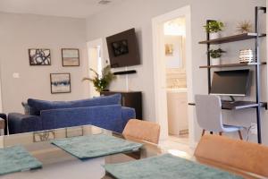 a living room with a blue couch and a table at Lil Havana-Brickell-South Beach in Miami