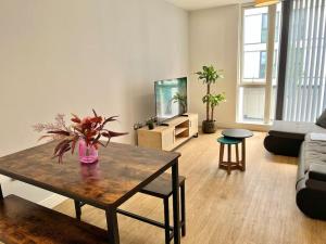 a living room with a table and a couch at Lovely 2 bedroom Apartment in Central Manchester in Manchester