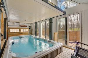 a large hot tub in a room with windows at Large Family Home with Patios, Gas Grill and Fire Pit! in Delaware