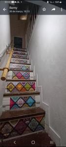 un escalier avec des couettes colorées. dans l'établissement AL- Almada 4, à Porto