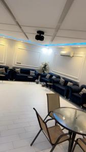 a meeting room with couches and a projection screen at شاليه النجمه الذهبيه in Al Harazat