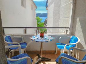 a small table and four chairs on a balcony at Amisos Boutique Hotel in Becici