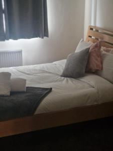 a bed with pillows on it in a bedroom at Guest Village in Hull