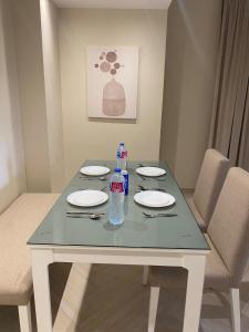 a table with plates and bottles of water on it at Dyafa Suites Giza in Cairo