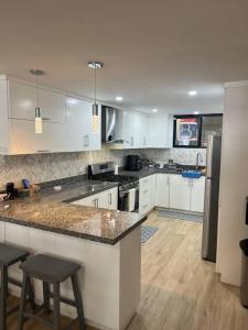 a kitchen with white cabinets and a counter top at Oceanfront Home in Rosarito Beach in Santa Mónica Sur