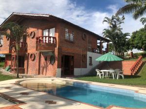 a house with a swimming pool in front of a house at Villa Ines in Playa Verde