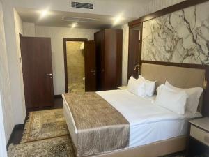 a bedroom with a large bed in a room at Best Western Plus Astana Hotel in Astana