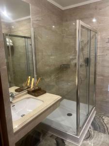 a bathroom with a shower and a sink at Best Western Plus Astana Hotel in Astana