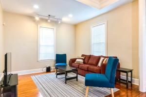 a living room with a couch and blue chairs at The Broadway Bungalow Walk to Riverwalk Dining! in Columbus