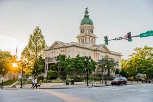 a large building with a clock tower on top of it at The Glory Glory Cottage Guest Suite Huge Yard in Athens