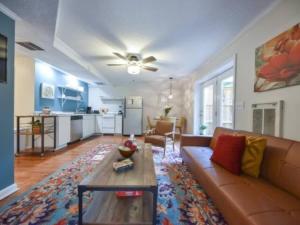 a living room with a couch and a table at The Glory Glory Doghouse Main House Huge Yard in Athens