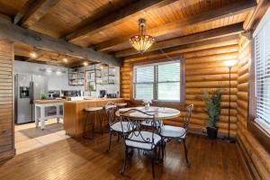 Campbell Log Cabin! Historic Charm, Modern Luxury في كلاركسفيل: مطبخ وغرفة طعام مع طاولة وكراسي