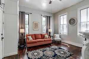 a living room with a couch and some windows at Mins from Downtown & Dining, Dauphin Darling 2 in Mobile