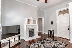 a living room with a fireplace and a tv at Mins from Downtown & Dining, Dauphin Darling 2 in Mobile