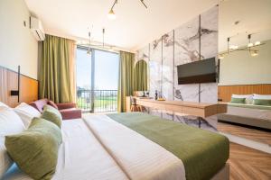 布德瓦Hotel Millennium by Aycon的配有一张大床和一台电视的酒店房间