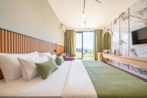 a hotel room with a large bed with a television at Hotel Millennium by Aycon in Budva