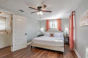 a bedroom with a white bed and a ceiling fan at Dauphin District Darling #4 Downtown, Dining in Mobile