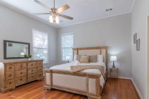 a bedroom with a bed and a ceiling fan at Mighty Mildred- Historic-Walkable-Mins to Riverwalk in Columbus