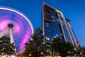 a large building with a large wheel in front of it at Club Wyndham Atlanta in Atlanta