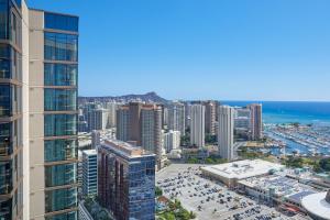an aerial view of a city with buildings and the ocean at Renaissance Honolulu Hotel & Spa in Honolulu