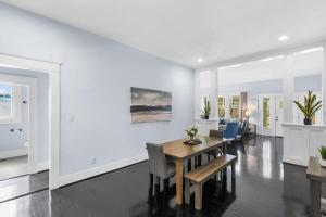 a dining room with white walls and a table and chairs at Near the Airport & Renovated East Lake Craftsman in Birmingham