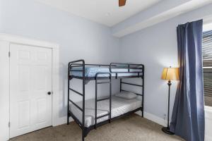 a bedroom with two bunk beds and a lamp at Near the Airport & Renovated East Lake Craftsman in Birmingham