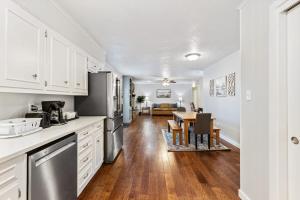 a kitchen with white cabinets and a table with chairs at Close to Everything Dining Shopping & Hiking in Little Rock