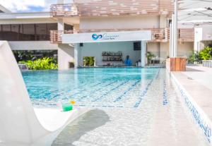 a swimming pool in front of a building at Sonesta Ocean Point Resort- All Inclusive - Adults Only in Maho Reef