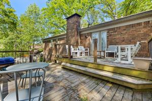 a deck with chairs and tables on a house at Close to Everything Dining Shopping & Hiking in Little Rock