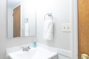Un baño blanco con lavabo y espejo. en Wrap-Around Porch Uptown Stay-Pets Welcome!, en Columbus 37 fotos más