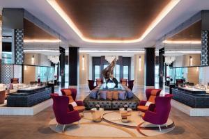 a lobby with a fountain in the center of a building at Baku Marriott Hotel Boulevard in Baku