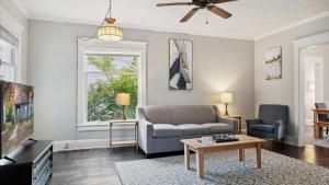 a living room with a couch and a tv at Min to Downtown South Bend - St Joseph's on Leland in South Bend