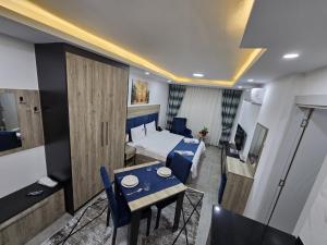 a small room with a bed and a table and chairs at Nurel Shark Residence in Kyrenia