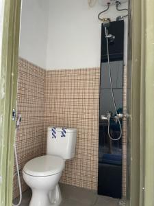 a bathroom with a toilet and a shower at MULIA INN Denpasar Imam Bonjol in Seminyak